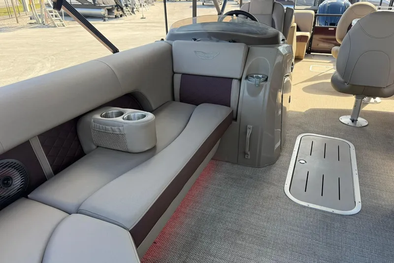 Slide: The Image of 2025 Bennington 23 LPD boat interior with plush seating and cup holders. - 12