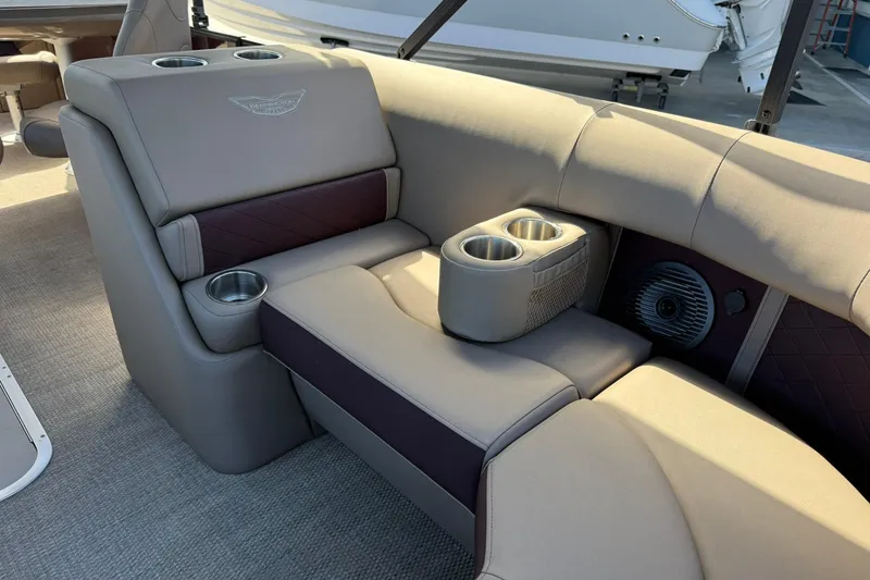 Slide: The Image of Luxurious seating area on 2025 Bennington 23 LPD boat with cup holders and speaker. - 13