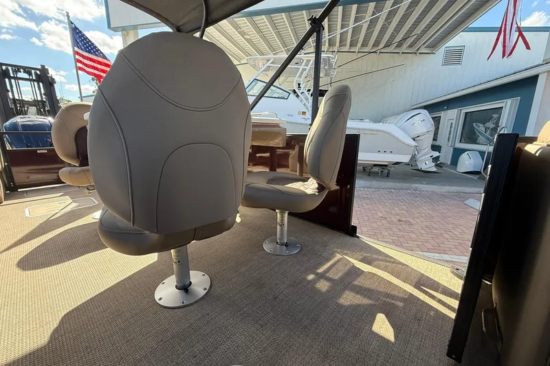 Slide: The Image of Interior of 2025 Bennington 23 LPD boat with plush seating and American flag. - 18