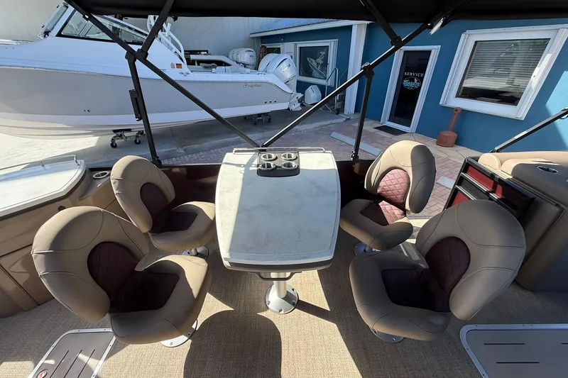 Slide: The Image of 2025 Bennington 23 LPD boat interior with four swivel chairs and a central table. - 24