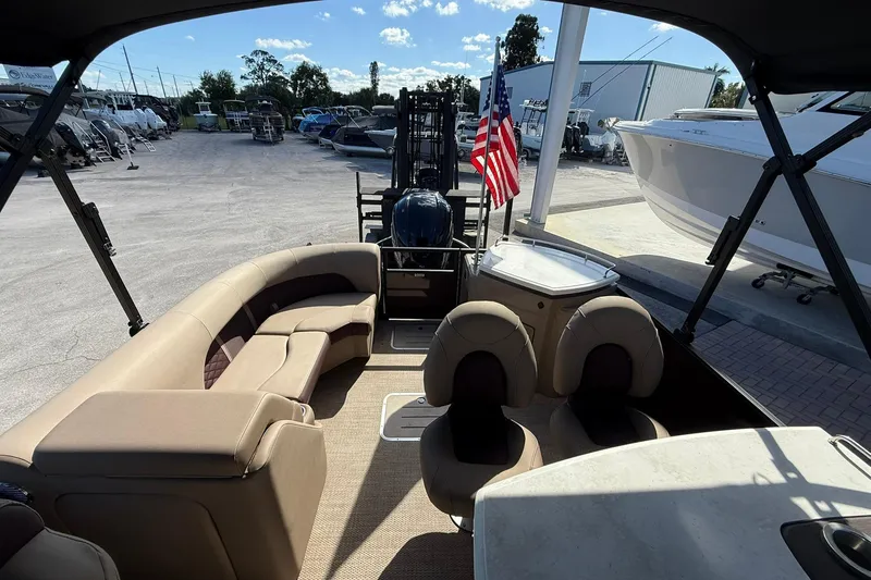 Slide: The Image of Interior view of 2025 Bennington 23 LPD pontoon boat with seating and American flag. - 25