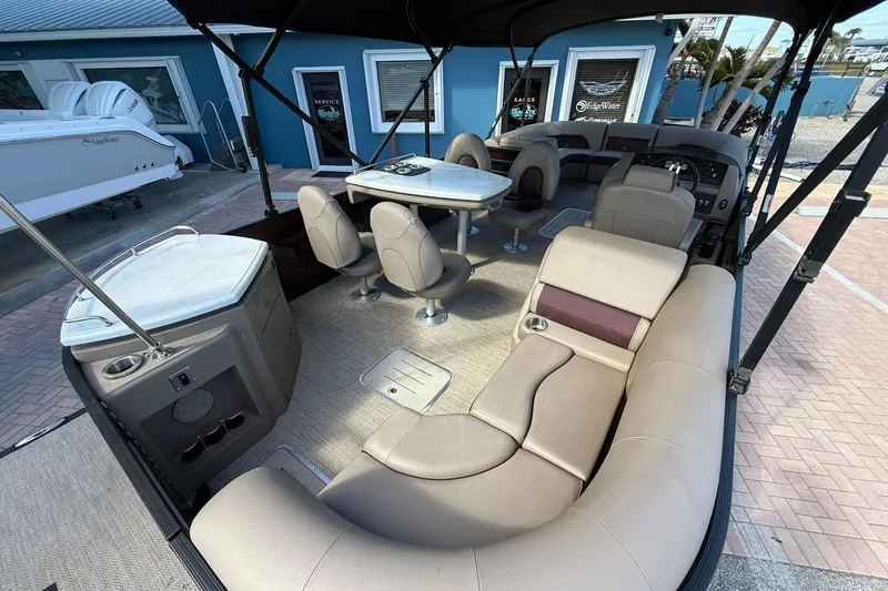 Slide: The Image of 2025 Bennington 23 LPD pontoon boat interior with luxurious seating and dining area. - 29