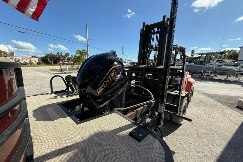 Slide: The Image of 2025 Bennington 23 LPD boat with Yamaha engine, displayed outdoors under clear sky. - 6