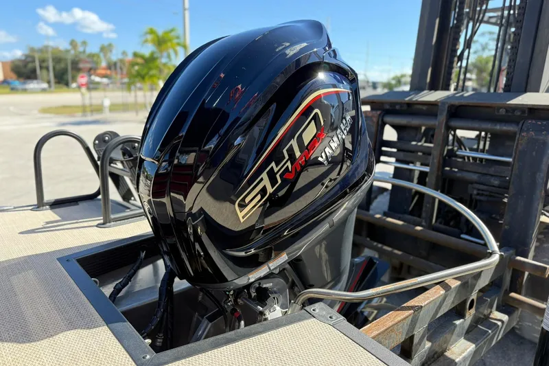 Slide: The Image of 2025 Bennington 23 LPD with Yamaha SHO VMAX outboard motor, parked outdoors. - 7