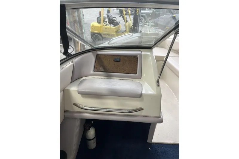 Slide: The Image of 1997 Regal Valanti 200 boat interior with white leather seating and blue carpet. - 12