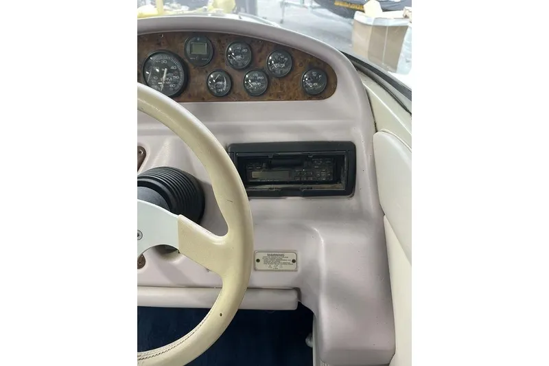 Slide: The Image of 1997 Regal Valanti 200 boat interior with seating and window view. - 13