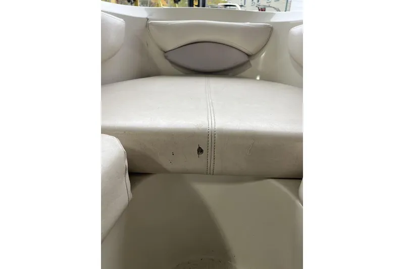 Slide: The Image of White leather seat in a 1997 Regal Valanti 200 boat interior. - 15