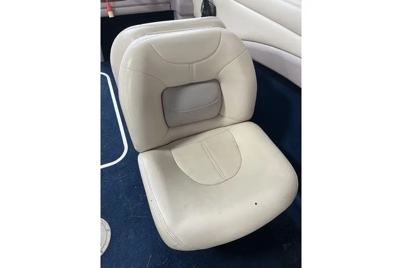 Slide: The Image of 1997 Regal Valanti 200 boat interior with white cushioned seating. - 18