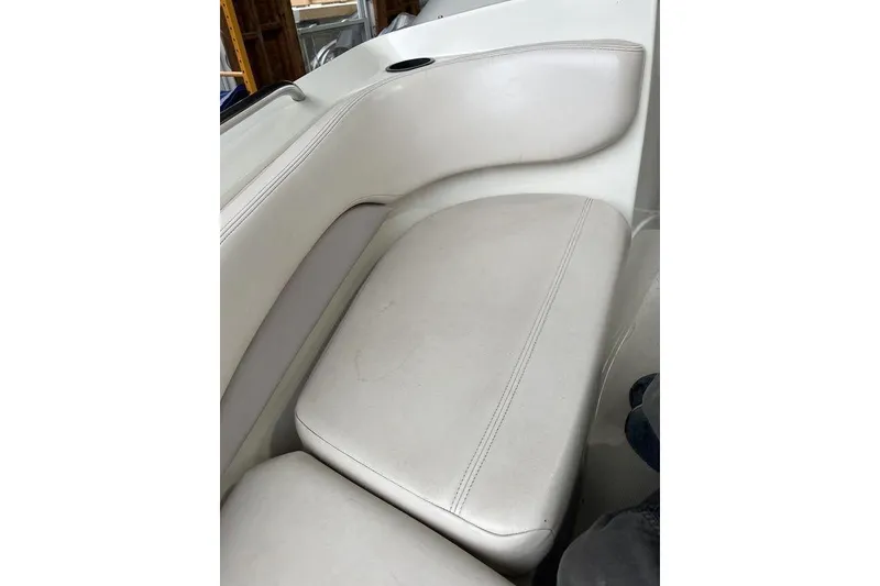 Slide: The Image of 1997 Regal Valanti 200 interior with worn white leather seats and blue carpet. - 19