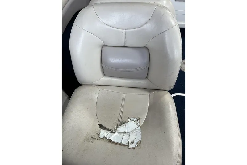 Slide: The Image of 1997 Regal Valanti 200 boat interior with white cushioned seating. - 22