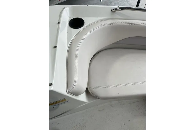 Slide: The Image of Interior seating of a 1997 Regal Valanti 200 boat, featuring white cushioned seats. - 23