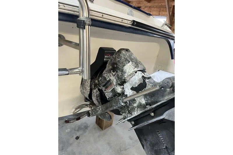 Slide: The Image of Interior of a 1997 Regal Valanti 200 boat with white seating and storage. - 25