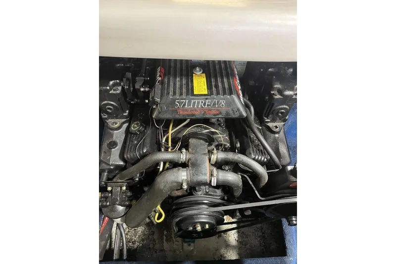 Slide: The Image of 1997 Regal Valanti 200 boat with blue cover in a garage setting. - 6