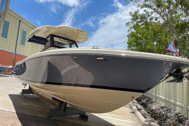 The Image of 2020 Chris-Craft Catalina 30 boat on display, sleek design under a clear blue sky. - 1