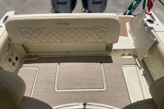 Slide: The Image of 2020 Chris-Craft Catalina 30 boat interior with cushioned seating and twin 300 engines. - 10