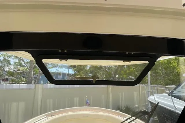 Slide: The Image of 2020 Chris-Craft Catalina 30 boat interior view with open hatch and outdoor scenery. - 25