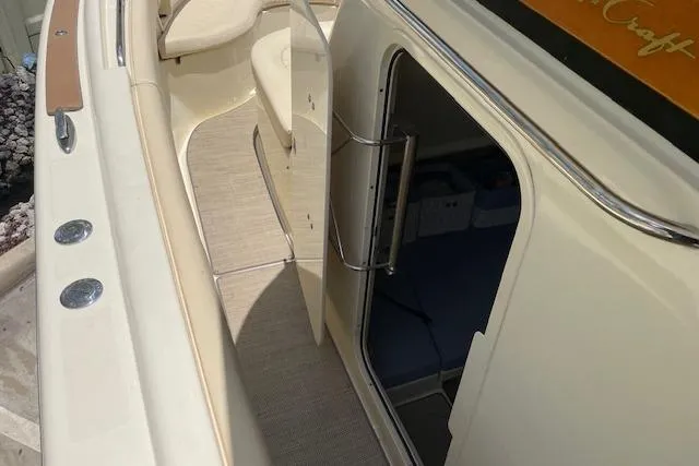 Slide: The Image of 2020 Chris-Craft Catalina 30 boat interior with open cabin door and seating area. - 28