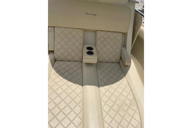 Slide: The Image of Luxurious seating on 2020 Chris-Craft Catalina 30 with diamond-pattern upholstery and cup holders. - 32