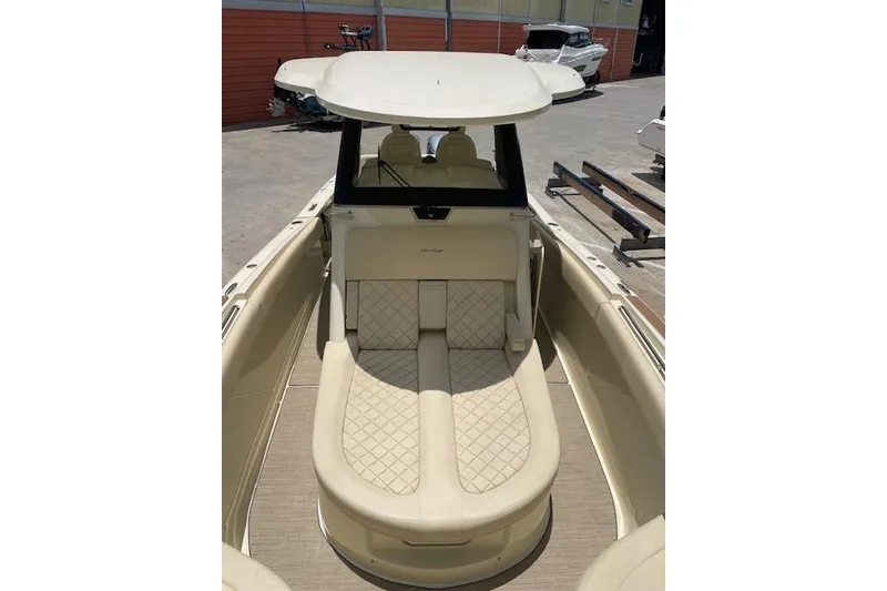 Slide: The Image of 2020 Chris-Craft Catalina 30 boat interior with beige cushioned seating. - 34