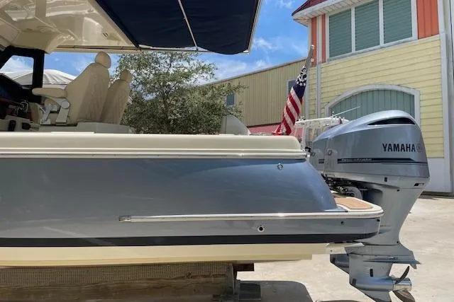 Slide: The Image of 2020 Chris-Craft Catalina 30 with Yamaha outboard motor, docked near colorful buildings. - 5