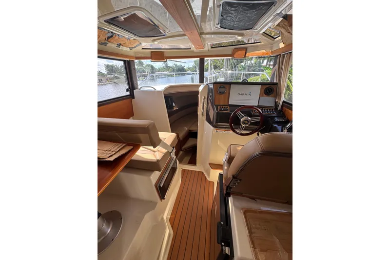 Slide: The Image of Interior of 2021 Ranger Tugs R-25 boat with Garmin navigation system and wood accents. - 12