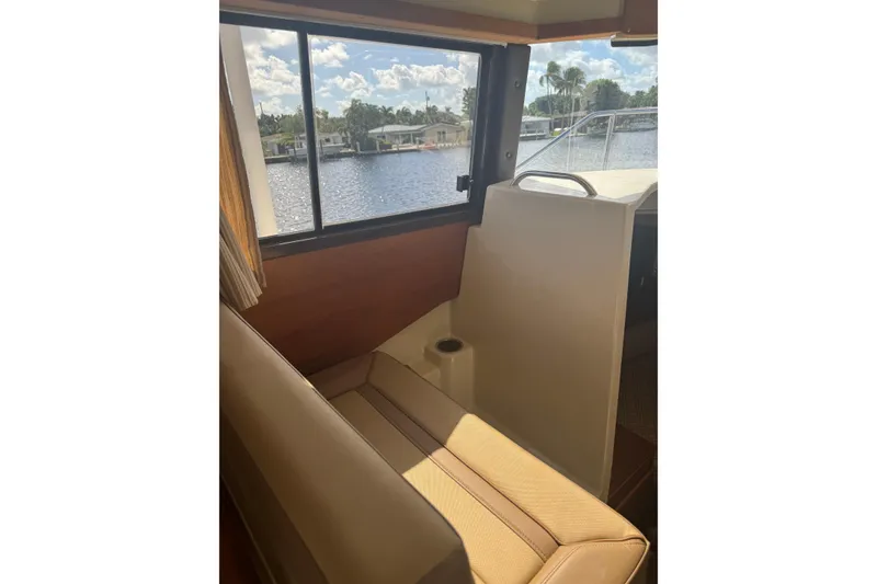 Slide: The Image of Interior view of 2021 Ranger Tugs R-25 boat with seating and window overlooking water. - 14