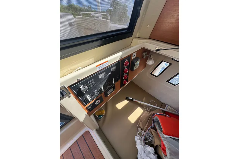 Slide: The Image of Interior view of 2021 Ranger Tugs R-25 boat control panel and cabin area. - 17