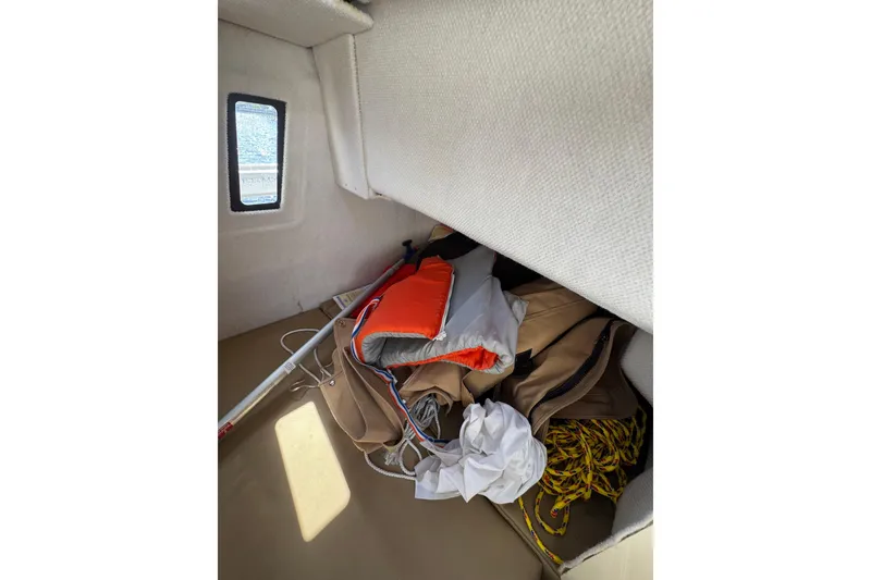 Slide: The Image of Interior storage of 2021 Ranger Tugs R-25 with life jacket and rope. - 18