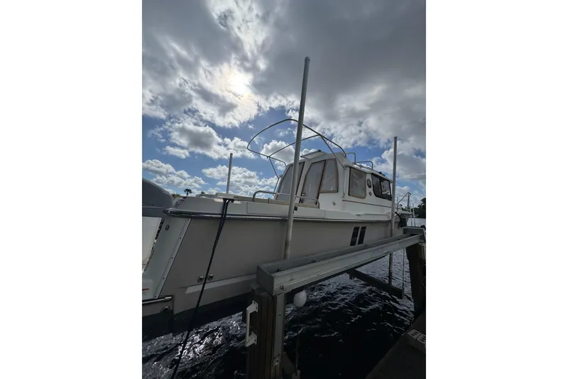 Slide: The Image of 2021 Ranger Tugs R-25 boat docked under cloudy sky. - 2