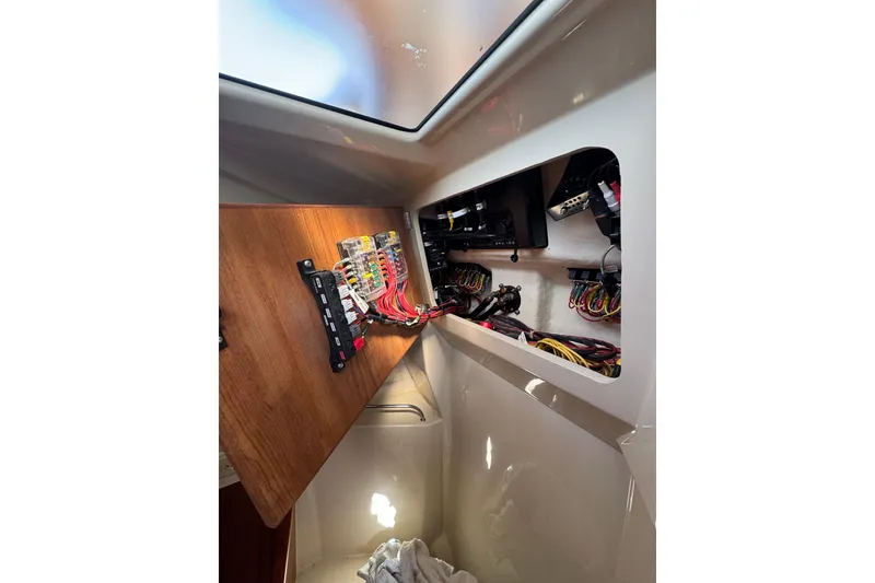 Slide: The Image of Electrical panel inside 2021 Ranger Tugs R-25 boat, showcasing wiring and components. - 22