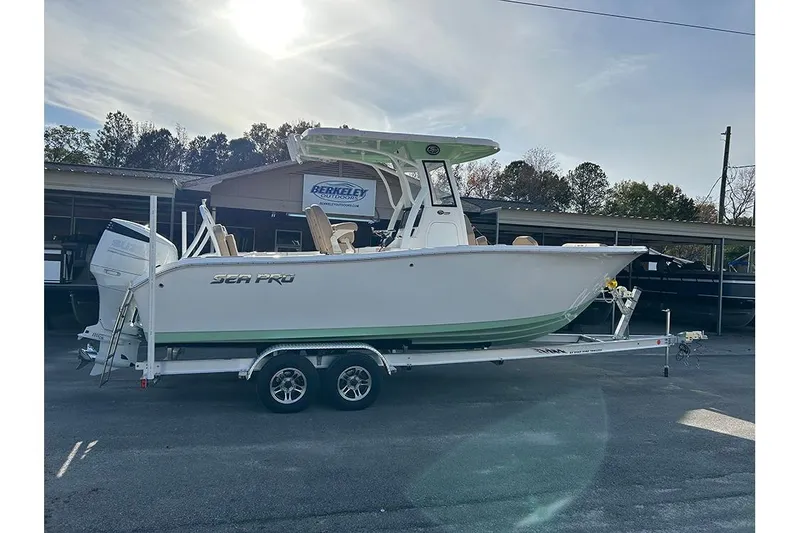 The Image of 2026 Sea Pro 245FLX Sandbar boat on trailer, outdoor dealership display. - 0