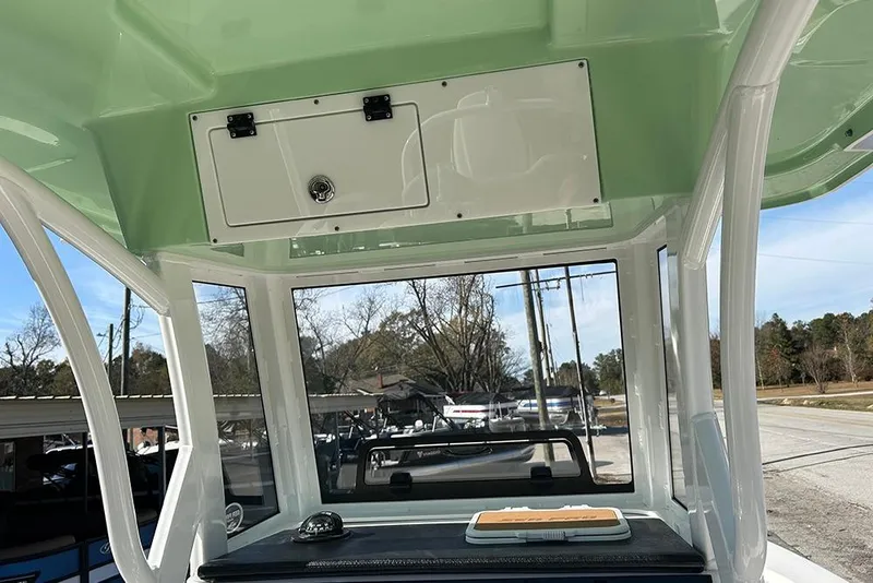 Slide: The Image of 2026 Sea Pro 245FLX Sandbar boat interior with storage compartment and console view. - 13