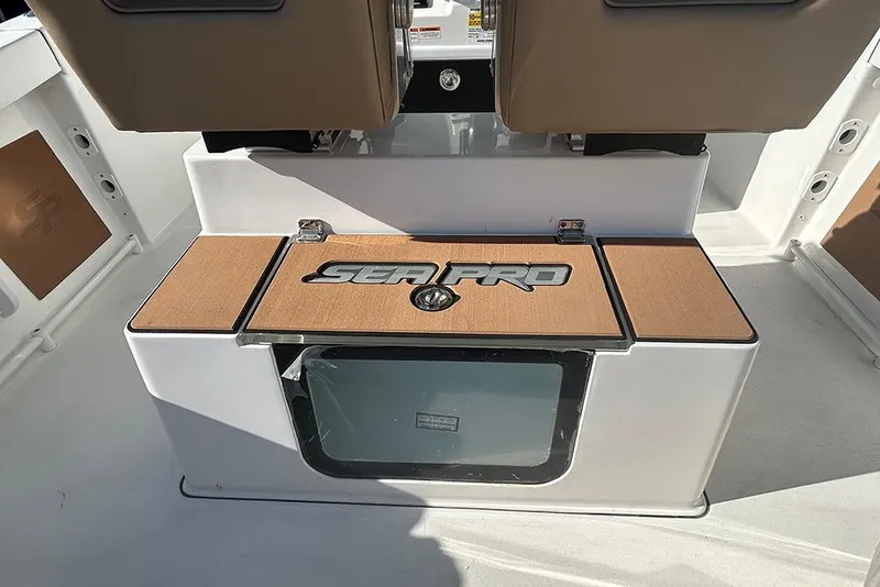 Slide: The Image of 2026 Sea Pro 245FLX Sandbar boat interior with branded storage compartment. - 15