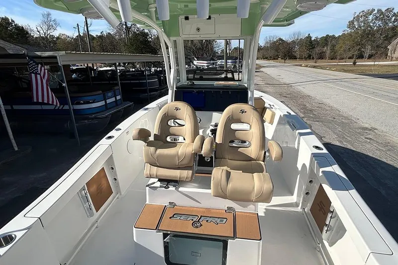 Slide: The Image of 2026 Sea Pro 245FLX Sandbar boat interior with tan seats and spacious deck. - 17