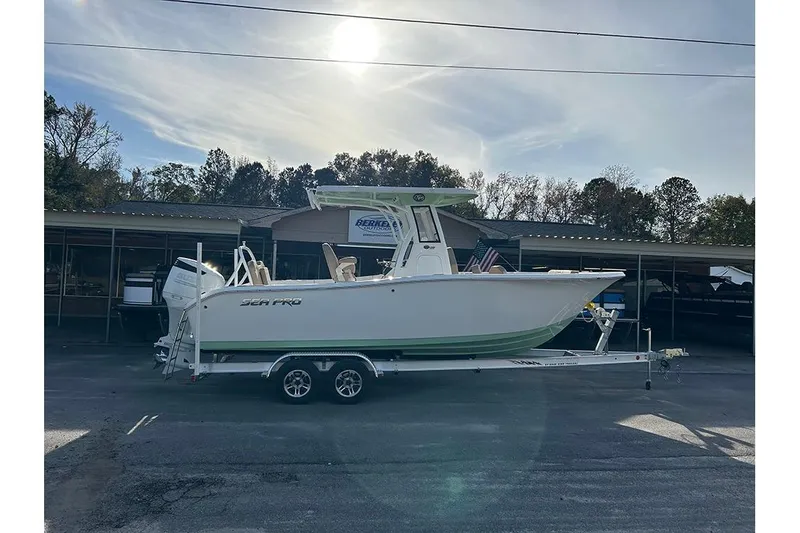 Slide: The Image of 2026 Sea Pro 245FLX Sandbar boat on trailer under a clear sky. - 2