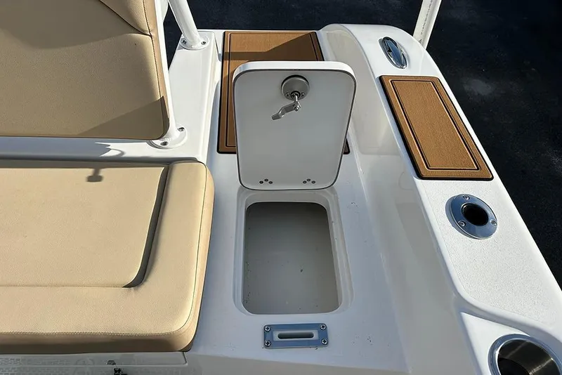 Slide: The Image of 2026 Sea Pro 245FLX Sandbar boat interior with storage compartment and cushioned seating. - 28