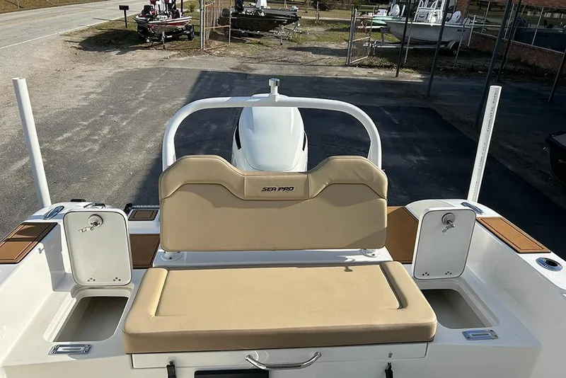 Slide: The Image of 2026 Sea Pro 245FLX Sandbar boat with beige seating and storage compartments. - 29