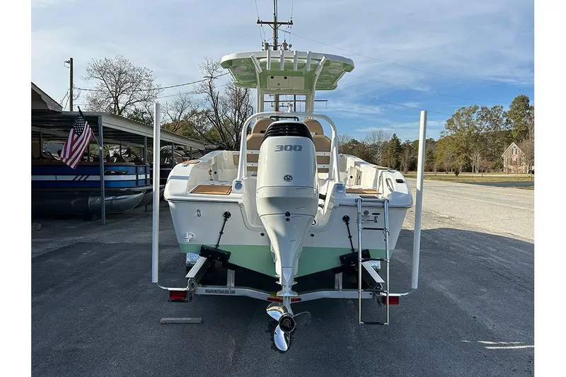 Slide: The Image of 2026 Sea Pro 245FLX Sandbar boat with powerful 300 HP engine, parked outdoors. - 3