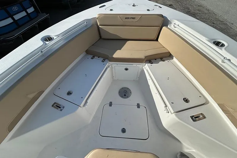 Slide: The Image of 2026 Sea Pro 245FLX Sandbar boat interior with beige seating and storage compartments. - 34
