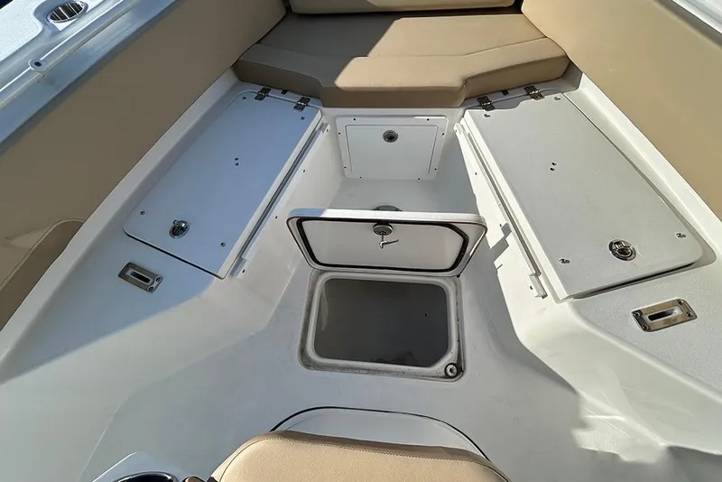 Slide: The Image of 2026 Sea Pro 245FLX Sandbar boat interior with storage compartments and seating. - 35