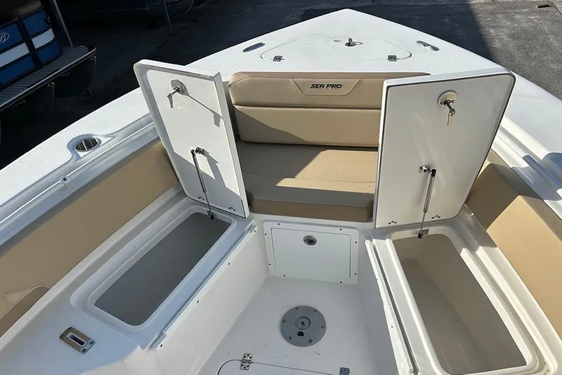 Slide: The Image of 2026 Sea Pro 245FLX Sandbar boat interior with open storage compartments. - 37