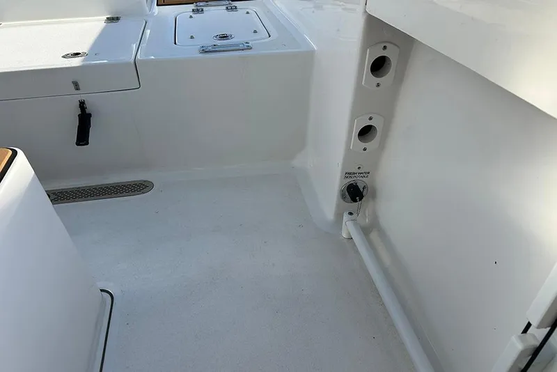 Slide: The Image of Interior view of 2026 Sea Pro 245FLX Sandbar boat, featuring storage compartments and fixtures. - 38