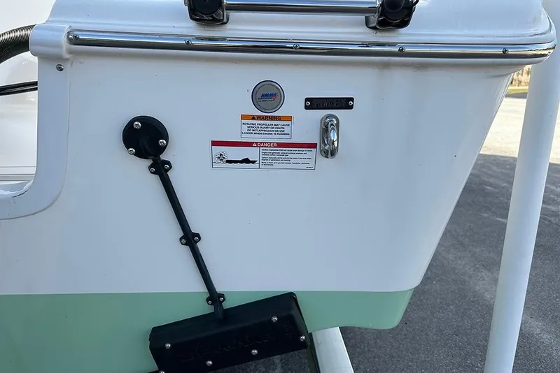 Slide: The Image of 2026 Sea Pro 245FLX Sandbar boat stern with warning labels and hardware. - 49