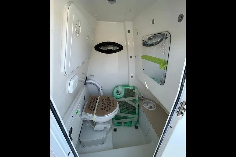 Slide: The Image of 2026 Sea Pro 245FLX Sandbar boat interior bathroom with toilet and sink. - 50