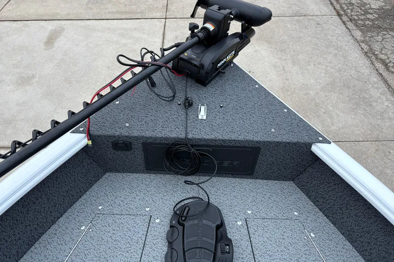 Slide: The Image of 2026 Lund 1800 Explorer Sport boat interior with trolling motor and control panel. - 10