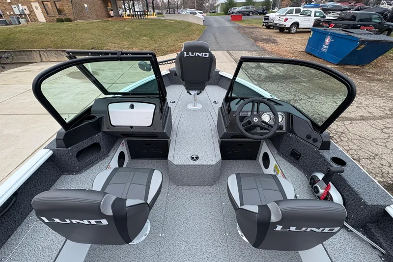 Slide: The Image of 2026 Lund 1800 Explorer Sport boat interior with dual seats and steering console. - 13