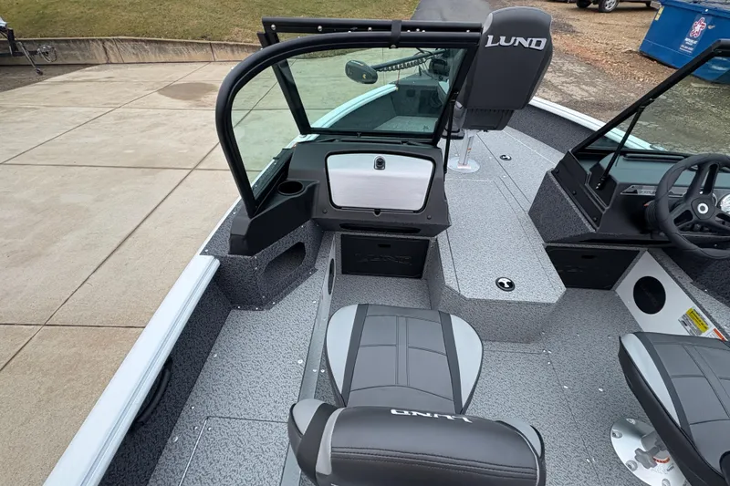 Slide: The Image of 2026 Lund 1800 Explorer Sport boat interior with seating and steering console. - 14