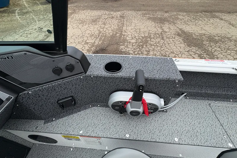 Slide: The Image of 2026 Lund 1800 Explorer Sport boat interior with control panel and textured flooring. - 19