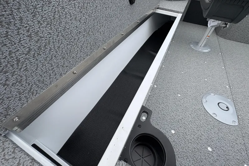Slide: The Image of 2026 Lund 1800 Explorer Sport boat interior with storage compartment and cup holder. - 29