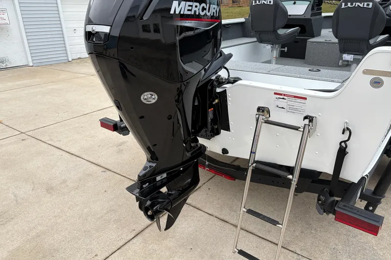 Slide: The Image of 2026 Lund 1800 Explorer Sport boat with Mercury outboard motor and boarding ladder. - 32